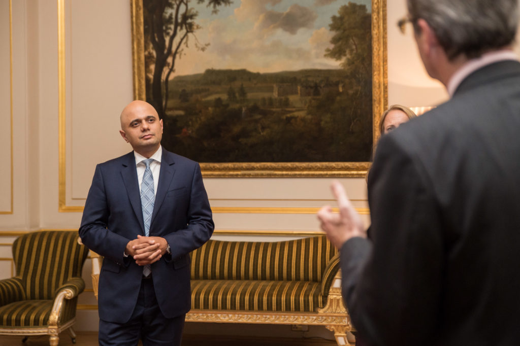 Sajid Javid listening another politician