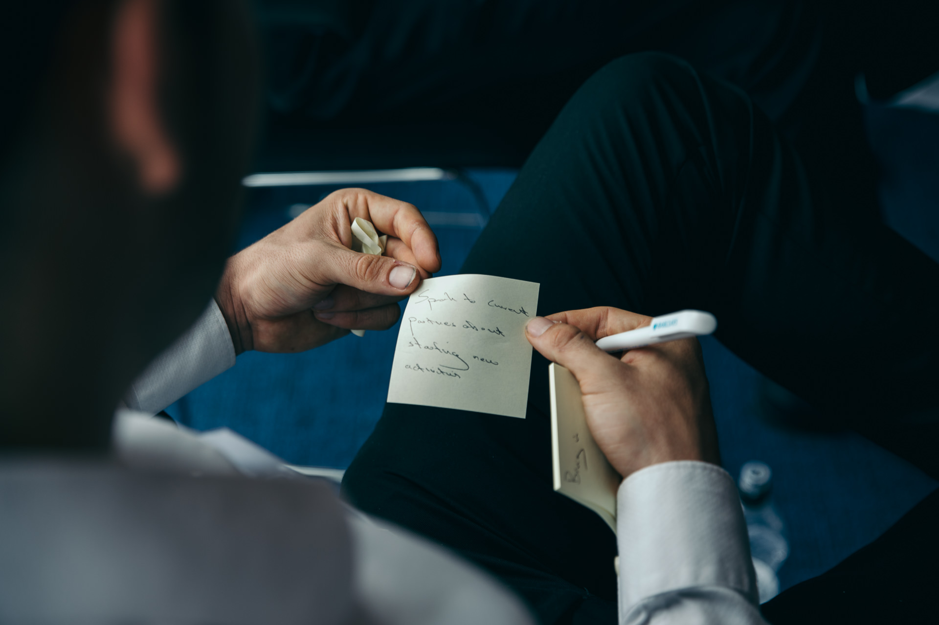 a man filling up sticky notes on his knee