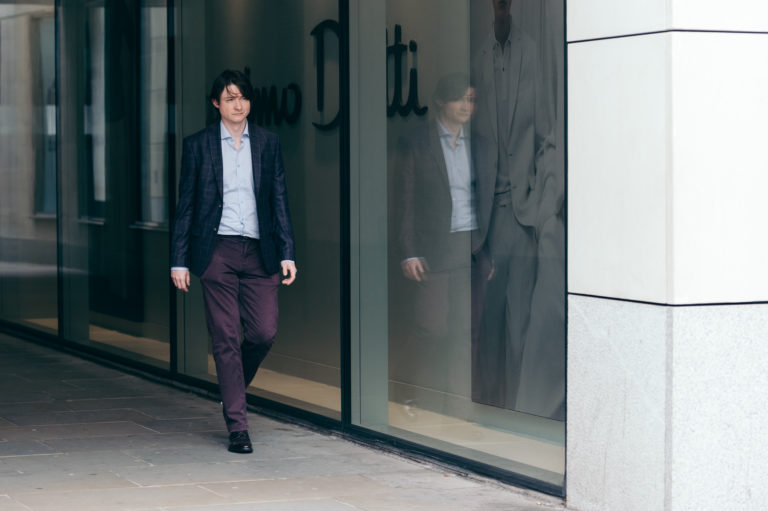 Man walking around empty city footpath